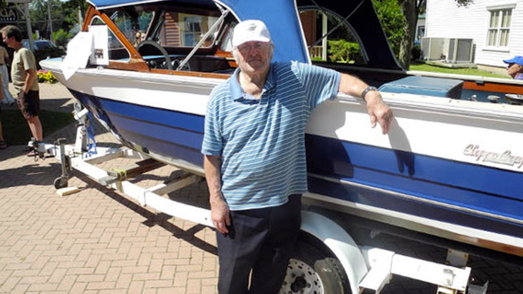 Charlie Cliffe standing in front of one of his classic boats!