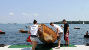 The crew lowers its first boat into the water